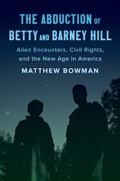 A photographic book cover has two human figures and tree tops silhouetted against a greenish night sky.